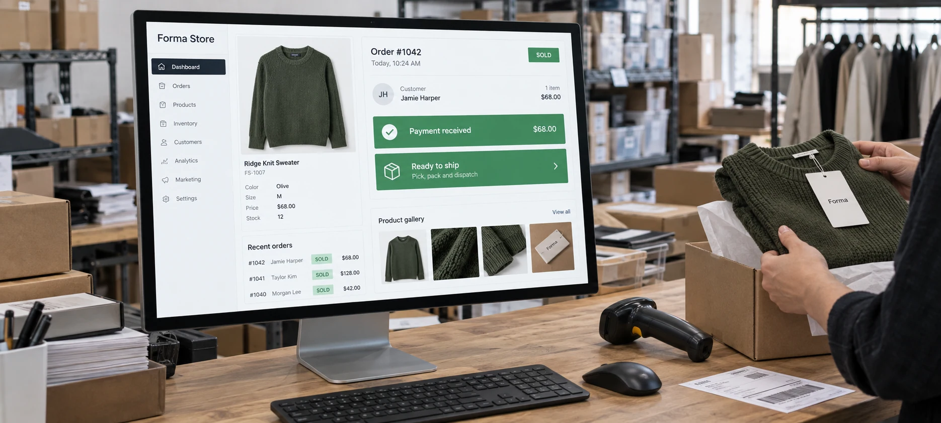 Wide close photograph of large desktop monitor on an ecommerce stockroom counter displaying fictional 'Forma Store' admin dashboard, product photography and prominent 'SOLD', 'Payment received', 'Ready to ship'
